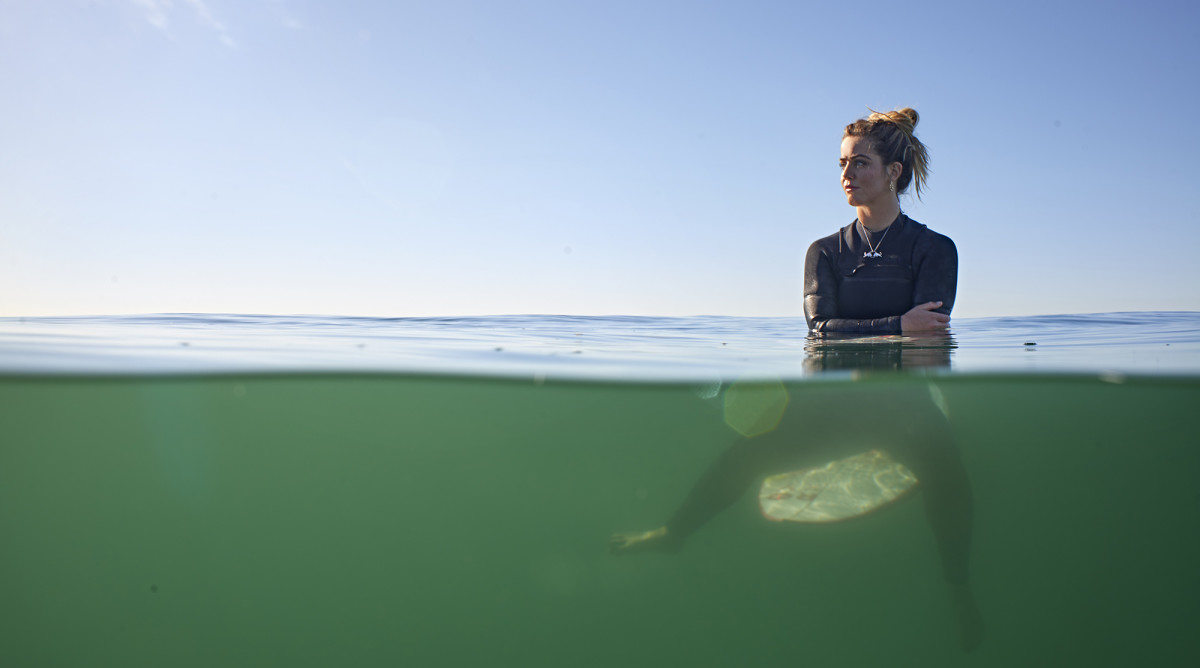 Caroline Marks on her surfboard.